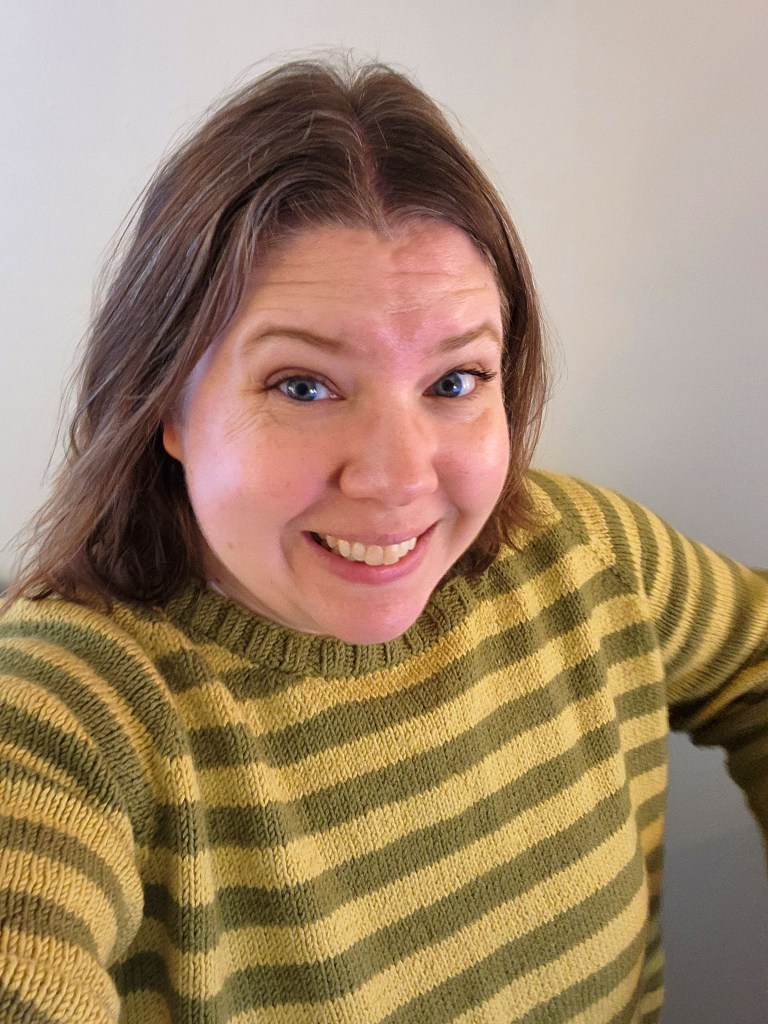 Woman wearing handmade green and yellow striped knit sweater