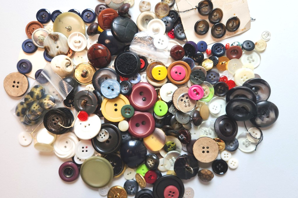 A pile of different sized and colored buttons to be used for future sewing projects.