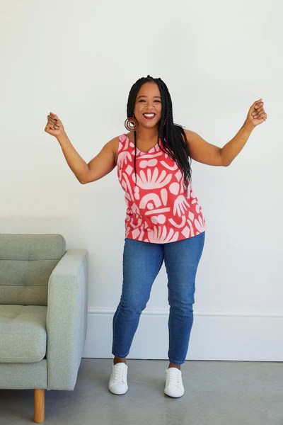 Curvy woman wearing Kersoe Top pattern from Cashmerette in a bold pink and red print fabric.