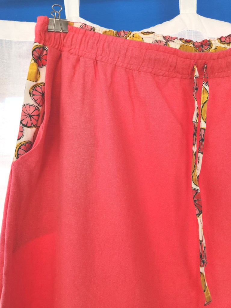 Contrasting fabric waistband, slash pockets, and drawstring on Love Notion Allegro Skirt