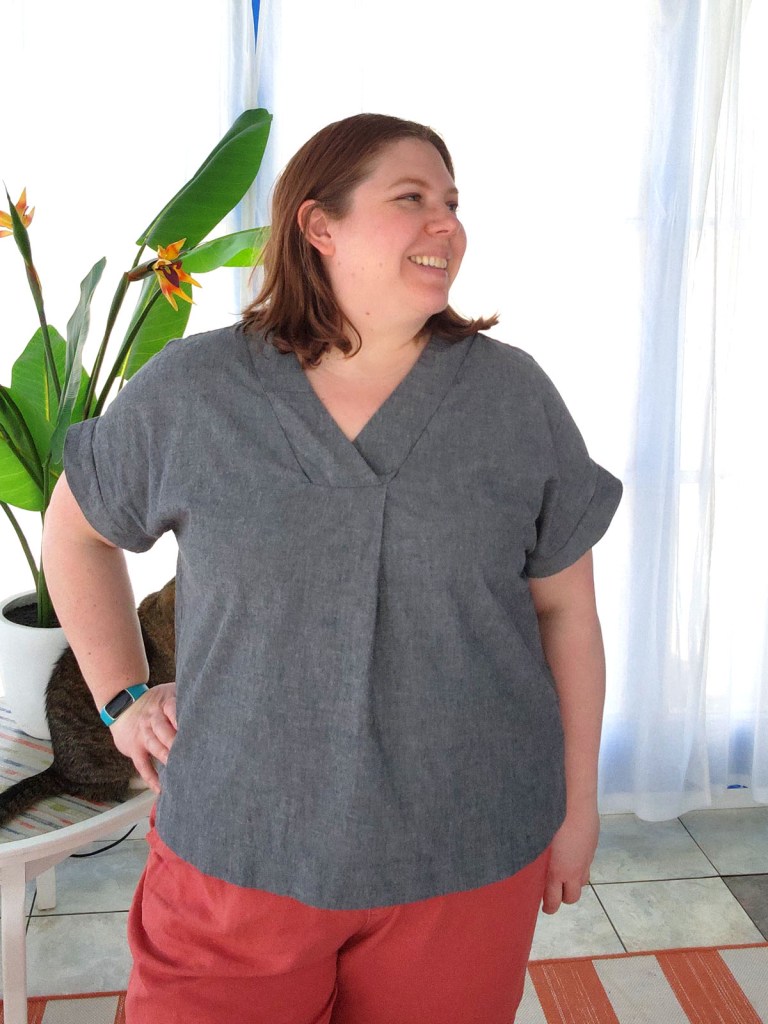 Love Notions Vivace Dolman top in blue-gray chambray. Background kitty cat also in frame. 