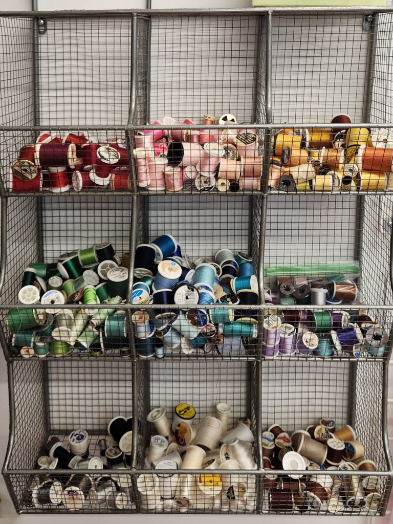 Spools of thread divided by color into baskets at The Stashery.